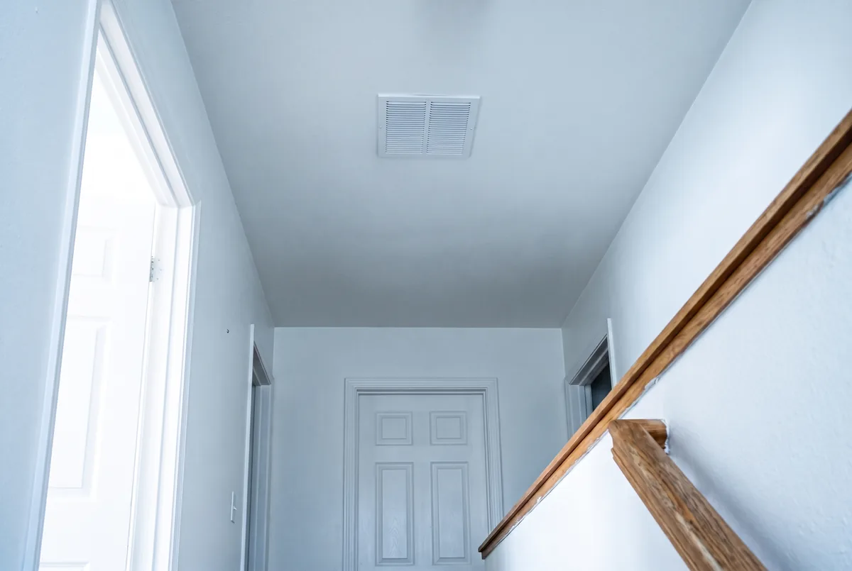 The same hallway ceiling replaced, refinished flat and repainted with a new vent register fitted